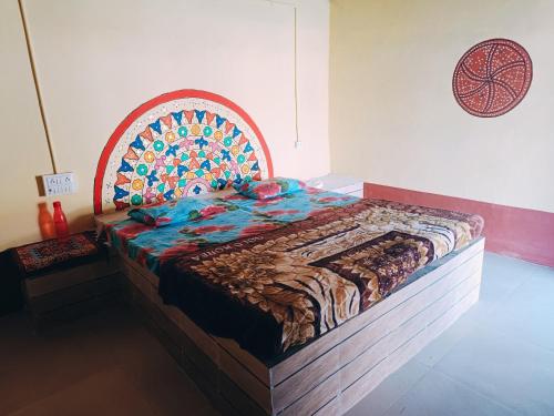 a large bed with a wooden headboard in a room at Rann Kutch Resort in Dhordo