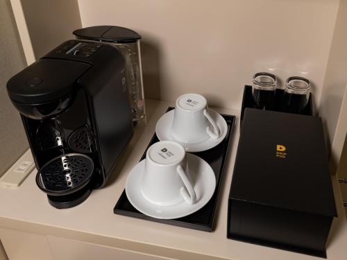 a counter with two cups and a coffee maker at Best Western Hotel Fino Tokyo Akihabara in Tokyo