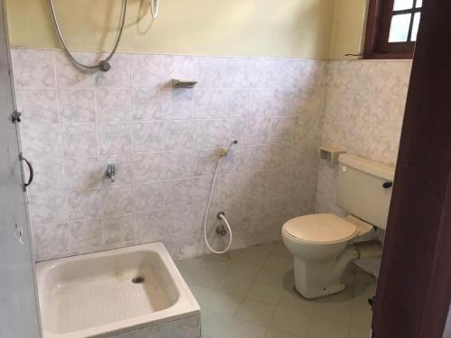 a bathroom with a toilet and a bath tub at Villa 6070 in Galle