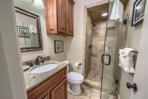 a bathroom with a toilet sink and a shower at IC 102 Comal Float Inn in New Braunfels