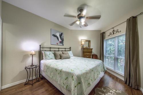 a bedroom with a bed and a ceiling fan at IC 102 Comal Float Inn in New Braunfels