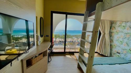 a bedroom with two bunk beds and a balcony at Mini Summer in Nanwan