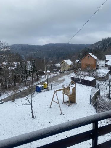 a yard covered in snow with a playground at Holiday home Maklen with big garden and jacuzzi in Brod Moravice