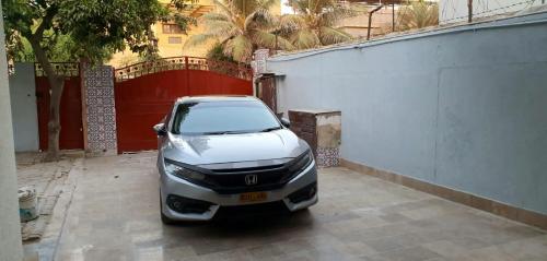 a car parked in a parking lot next to a building at Shelton House in Karachi