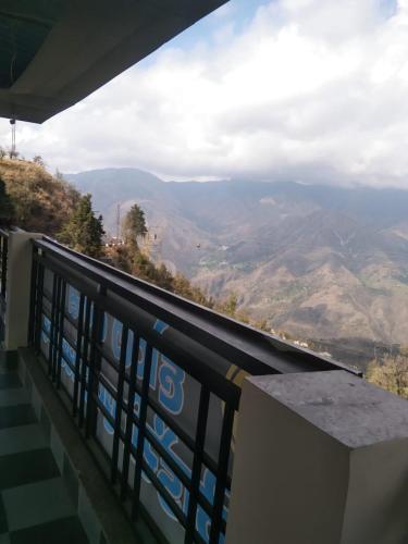 a balcony with a view of the mountains at Badrinath B V by prithvi yatra hotels in Badrīnāth