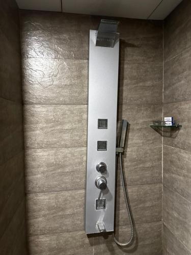 a shower in a bathroom with a shower at Weekend Address in Surat