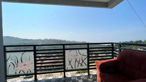 a balcony with a view of a body of water at Summer Dreams Cottage Kodaikanal in Kodaikānāl
