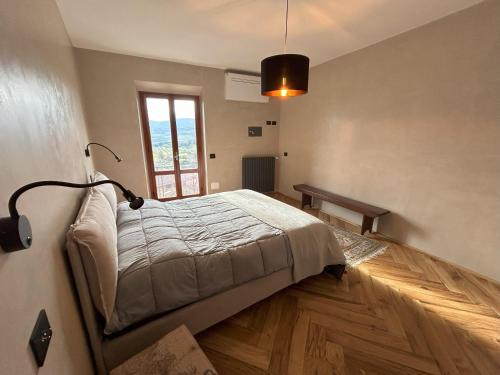 a bedroom with a bed and a lamp on the wall at Garibaldi14 in Chianciano Terme