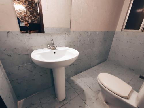 a bathroom with a sink and a toilet at Daily BASIS 3-BEDROOMS FAMILY APARTMENT in Islamabad