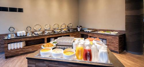 a buffet in a restaurant with a tray of food at Grand Mer Hotel Seogwipo Ocean in Seogwipo