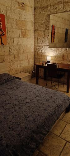 a bedroom with a bed and a table and a desk at Black Rose in Bari