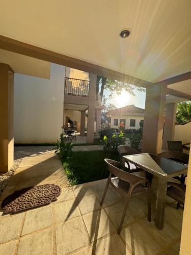 a patio with a table and chairs in a yard at Ocean Breeze Condo in Coco