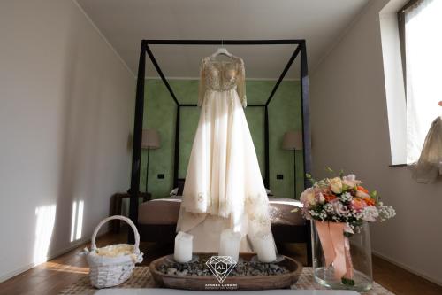 a wedding dress hanging in front of a mirror at La Rondanina in Castelnuovo Fogliani