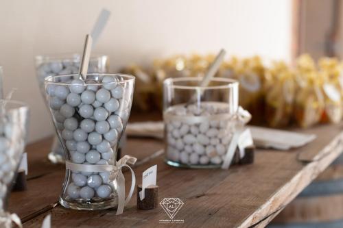 a table with two vases filled with spheres on it at La Rondanina in Castelnuovo Fogliani