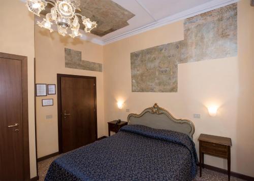 Ένα ή περισσότερα κρεβάτια σε δωμάτιο στο Hotel Guerrato