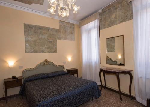 Ένα ή περισσότερα κρεβάτια σε δωμάτιο στο Hotel Guerrato