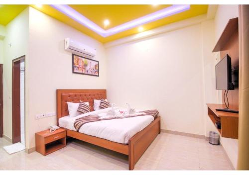 a bedroom with a bed and a television in it at Amit House in Greater Noida