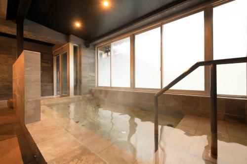 an indoor pool in a house with windows at Yutorelo Tsuwano in Tsuwano