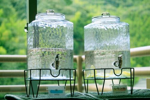 two glass jars sitting on top of a table at Yutorelo Tsuwano in Tsuwano