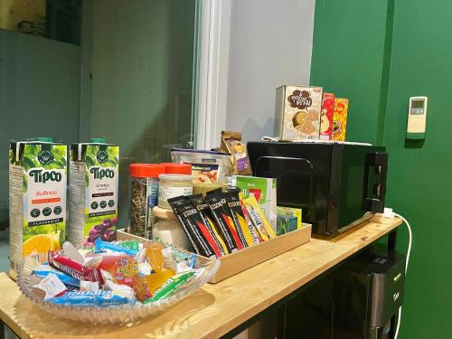 a counter top with a microwave and some food at Studio room in Mango House in Phuket Town