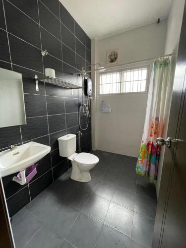 La salle de bains est pourvue de toilettes et d'un lavabo. dans l'établissement Eyu Sweet Home in Sitiawan 10-13 pax free wifi, à Sitiawan
