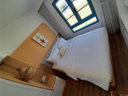 a bedroom with a large bed and a window at Villa NovawoRld Phan Thiết in Bình Sum
