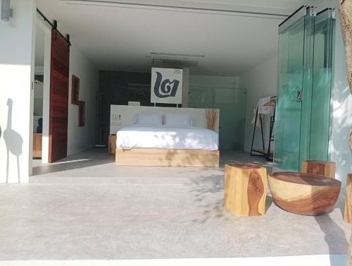 a bedroom with a bed and two wooden logs at KPG Suite Dream in Ban Nua