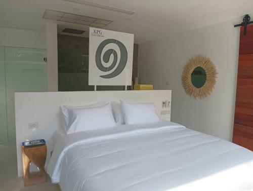 a large white bed in a room with a sign at KPG Suite Dream in Ban Nua
