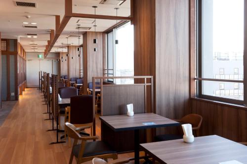 a row of tables and chairs in a restaurant at Kumamoto Washington Hotel Plaza in Kumamoto