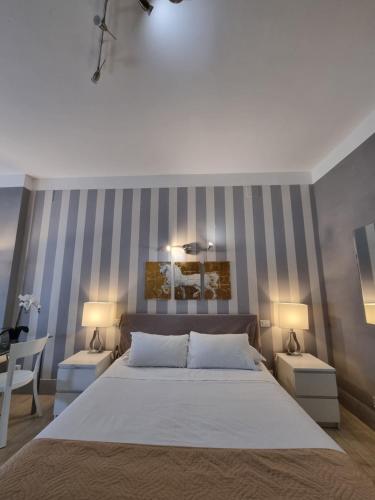 a bedroom with a large bed with two night stands at B&B Pescara Centro Luxury Suite in Pescara