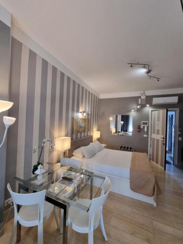 a hotel room with a bed and a table and chairs at B&B Pescara Centro Luxury Suite in Pescara