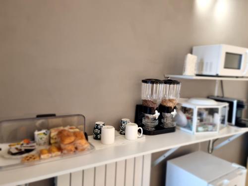a shelf with pastries and other food items on it at B&B Pescara Centro Luxury Suite in Pescara