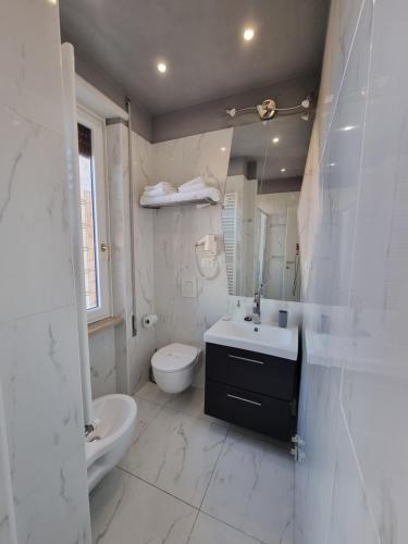 a white bathroom with a sink and a toilet at B&B Pescara Centro Luxury Suite in Pescara