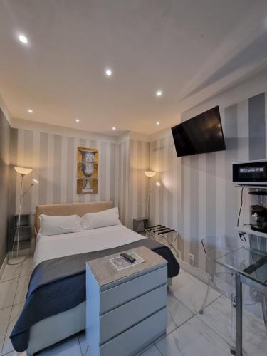 a bedroom with a bed and a flat screen tv at B&B Pescara Centro Luxury Suite in Pescara