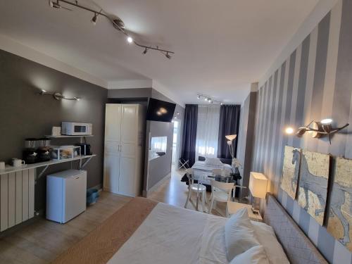 a bedroom with a bed and a living room at B&B Pescara Centro Luxury Suite in Pescara