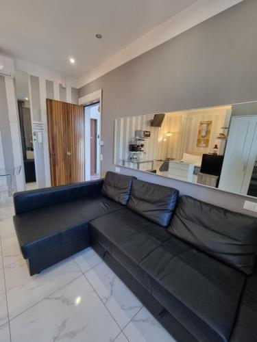 a large black couch in a living room at B&B Pescara Centro Luxury Suite in Pescara