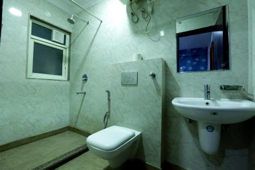 a bathroom with a toilet and a sink at Hotel Venture Near New Delhi International Airport in New Delhi