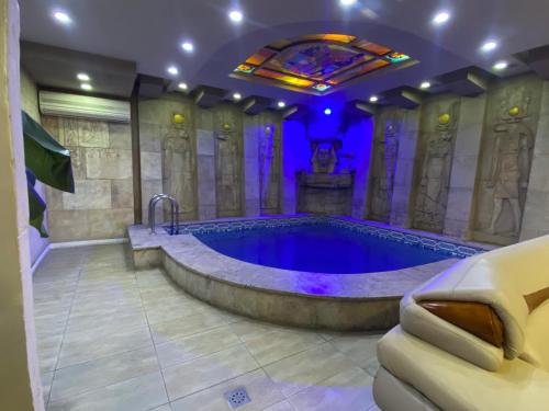 een grote badkamer met een bad en een glas-in-loodraam bij SpaHotel in Jerevan