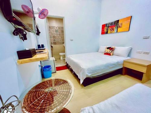 a room with two beds and a fan at Kenting Bayview Hotel in Nanwan