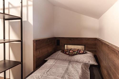 a small bedroom with a bed in the corner at PHILSON Apartments in Saalbach Hinterglemm