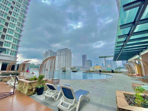 a patio with chairs and a swimming pool on a building at KL Q520 Premium Suite Room in Kuala Lumpur