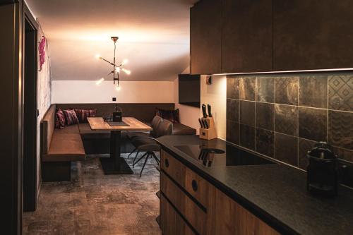 a kitchen with a table and a dining room at PHILSON Apartments in Saalbach Hinterglemm