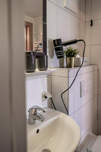 a bathroom with a sink and a mirror at PHILSON Apartments in Saalbach Hinterglemm