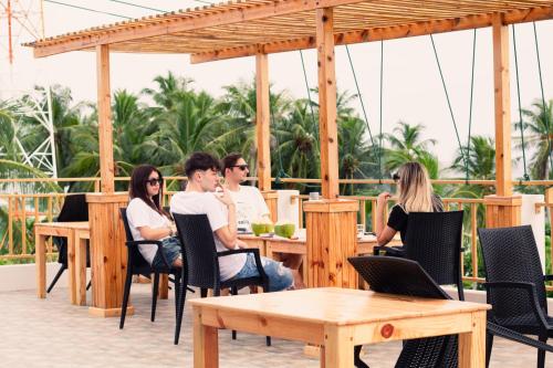 a group of people sitting at a table at Manta Sea View Himandhoo in Himandhoo 