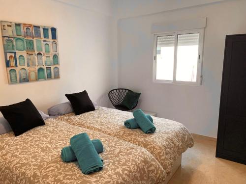 a bedroom with a bed with two pillows on it at Bohemio in Málaga
