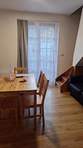 a dining room with a wooden table and chairs at Apartments Prekmurska vas - Vital Resort in Moravske Toplice
