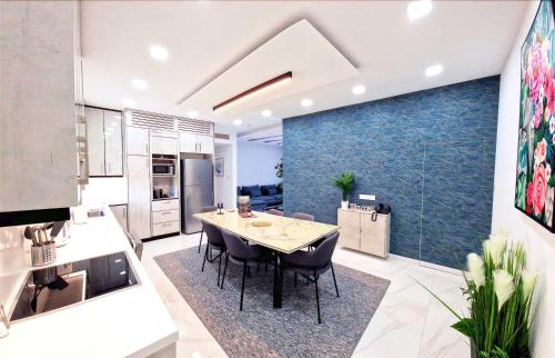 a kitchen and dining room with a table and chairs at Sveltos Residence Suites in Larnaca