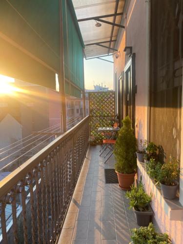 a balcony with potted plants on a building at Appartamento Benaco 98 mq a Milano - Fondazione Prada in Milan
