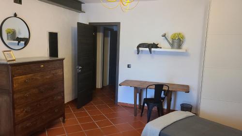 a bedroom with a table and a bed and a mirror at CASA CUEVA A-TIPICA in Pegalajar