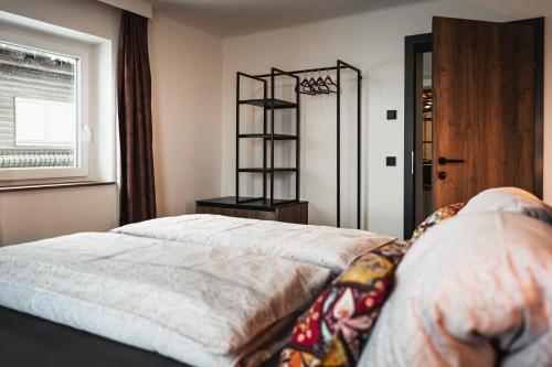 a bedroom with a bed and a window at PHILSON Apartments in Saalbach Hinterglemm